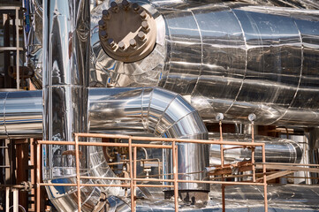 Industrial pipes and machinery at a chemical plant showcasing metalwork and structural design in a...