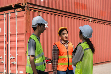 Construction workers discussing safety measures engineers communicating on-site near shipping containers