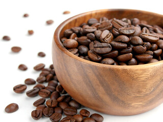 Fototapeta premium Scoop of coffee beans in a bag on white background. Coffee in scoop isolated. Top view of coffee