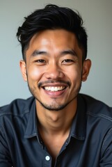 Fototapeta premium Portrait of smiling young asian businessman showing happiness and confidence