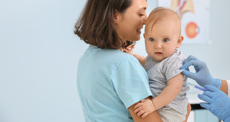 Pediatrician vaccinating little baby in clinic