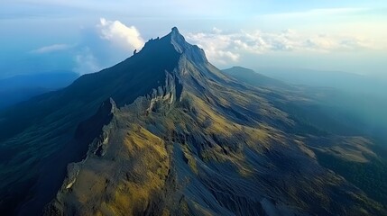 Majestic mountain peak shrouded in mist, lush valleys below, serene landscape ideal for adventure and exploration themes.