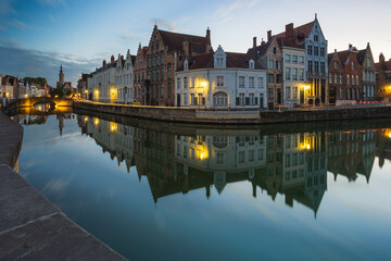 Fototapeta premium View of Bruges skyline skyline at Spiegelrei Canal during dusk, Bruges, Belgium