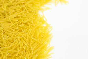 Obraz premium Uncooked vermicelli Pasta with Copy Space on White Background. Raw and Dry vermicelli.