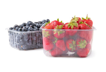 Plastic containers with fresh blueberry and strawberry on white background