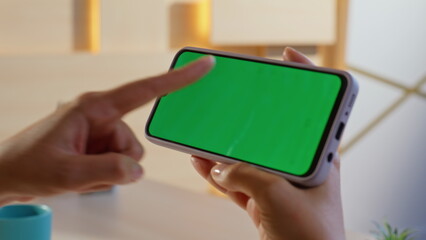 Finger tapping horizontal mockup cellphone turning on online app at home closeup