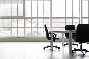 Interior of modern office with table prepared for business meeting