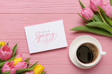 Greeting card with text HELLO SPRING, beautiful tulips and cup of coffee on pink wooden background