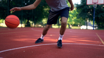 Close-up of an African American player leading the ball and dribbling during a focused training session