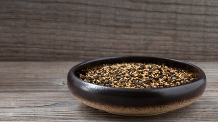 Homemade vegan furikake seasoning with nori seaweed. Japanese condiment. Copy space. Rustic wooden background.