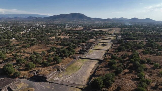 Avenue of the Dead with the Temple of Quetzalcoatl in the background at the archaeological site of Teotihuacan, Mexico. Aerial camera slowly moving forward