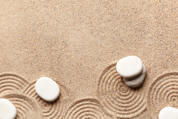 Spa stones on light sand with pattern