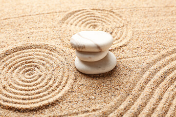Spa stones on sand background