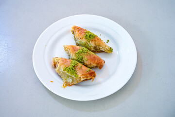 Turkish Dessert Sobiyet, havuc dilimi, midye baklava, mussels baklava and classic baklava with Pistachio . Cikoltali cevizli, fistikli soguk Baklava, top view.