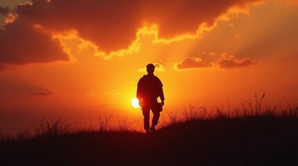 A soldier walks across a grassy field at sunset, the sky ablaze with vibrant orange and red hues.