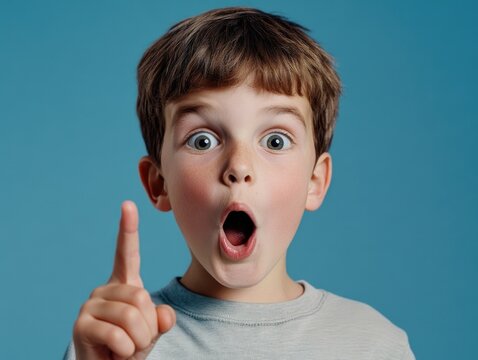 The image showcases a young boy, seemingly in the middle of a storytelling session or an explanation. He has his hand on his chest as if emphasizing a point, while holding up a finger in a gesture