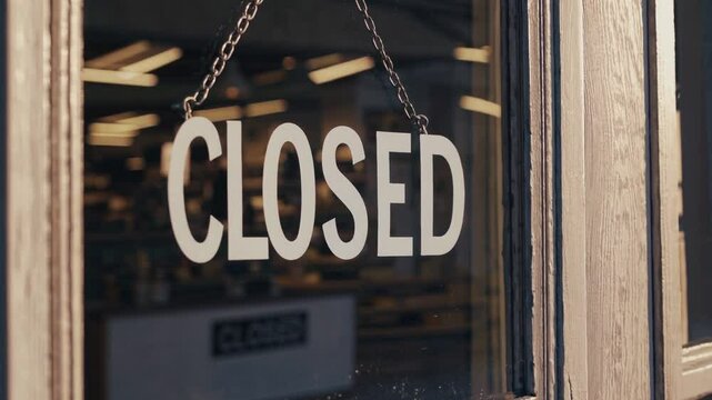 Closed Sign Hanging on Retail Store Window