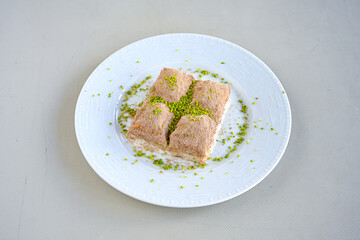 Turkish Dessert Sobiyet, havuc dilimi, midye baklava, mussels baklava and classic baklava with Pistachio . Cikoltali cevizli, fistikli soguk Baklava, top view.