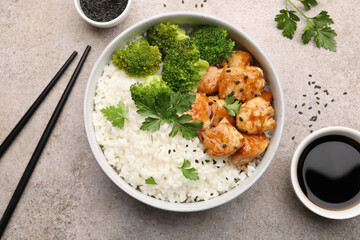Tasty rice with broccoli and chicken served on grey table, flat lay