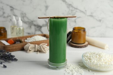 Soy wax candle with stabilizer on white wooden table