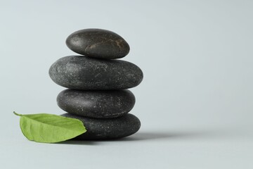 Stack of rocks on gray background, space for text. Harmony and life balance