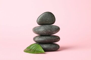 Stack of rocks on light pink background. Harmony and life balance