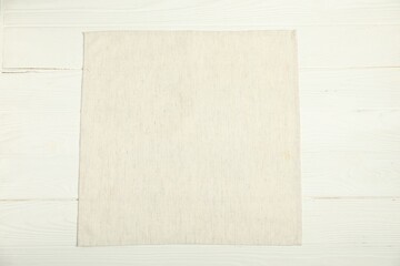 Light napkin on white wooden table, top view