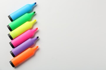 Bright highlighters on white background, flat lay. Space for text