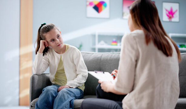 young psychiatrist comforts a sad ADHD child during