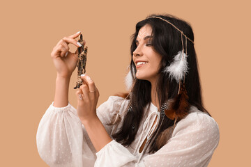 Beautiful female shaman on beige background