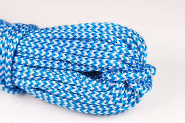 Blue rope made of synthetic polyester material for climbing. Close-up background.