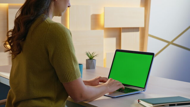 Girl secretary typing report at green screen laptop in company office closeup.  - Powered by Adobe