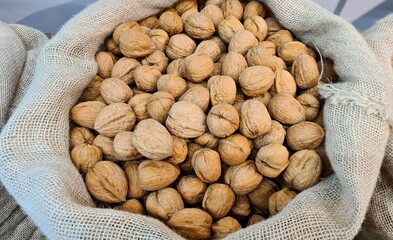 The ripened in-shell nuts are filled into large bags for sale at the city market