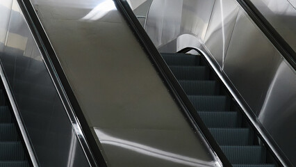Obraz premium Station escalators. Empty escalator steps, moving staircase