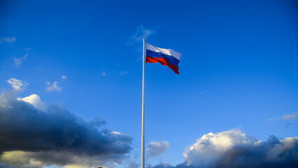 The Russian flag is flying against the blue sky