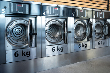 Spacious laundromat with a row of high-efficiency dryers and nea