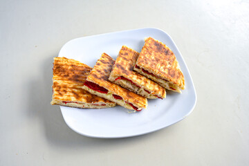 Turkish karisik atom Ayvalik tost ( kasarli bazlama tost) . Sucuklu, Kasarli, kavurmali karisik tost. Flat baked bread toasted. Karisik bazlama tost .  