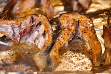 grilled salmon steaks lying on a tray in the oven close-up