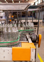 Glass factory, production of glass containers. Molten glass is blown into molds. Robotics in industry. Modern technologies, robotic machines produce products. Technological work at the plant.