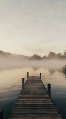 Fototapeta premium Serene Wooden Dock Beneath Misty Morning Sky Over Calm Water