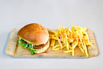 Big tasty burger with beef cutlet on a plate. Hamburger, cheeseburger with mushroom. Hamburger, Mexica, mushroom double burger.  Crispy chicken burger. With french fries, patates kizartmasi.