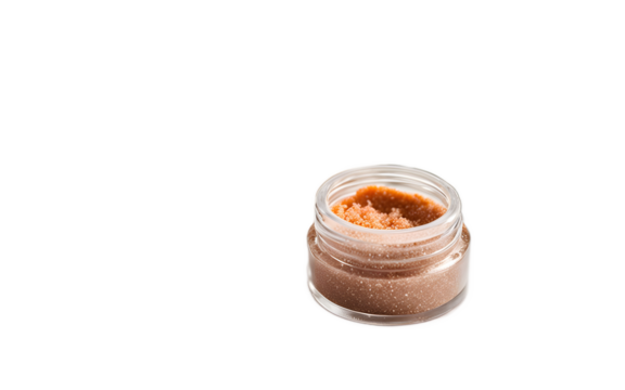 A luxurious sugar lip scrub in a small round container on a white empty plain background