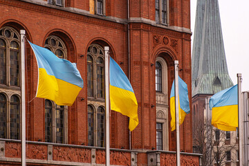 Multiple ukrainian flags waving in front of Rotes Rathaus builidng, Berlin city hall, representing...