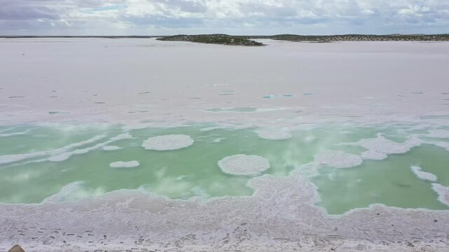 Saline ponds in Guerrero Negro, Mexico. Turquoise water creates intricate patterns on the surface of a salt lake, showcasing a stunning natural landscape