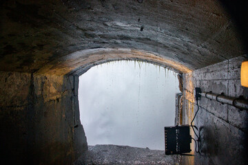 Looking through a tunnel under Horseshoe Falls at the waterfalls water flowing down