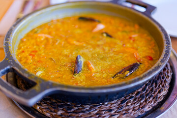 Seafood paella with mussels served in Tenerife Spain. Traditional Spanish rice dish. Freshly cooked creamy paella.