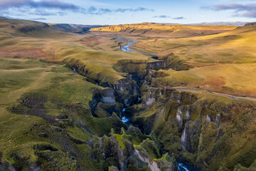 Birdview of Fjadrargljufur canyon with a river meandering through the middle of the canyon. Color landscape in a famous place in Iceland. Scenic nature environment.