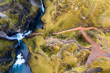 Spectacular view into fjadrargljufur canyon in southern Iceland, landscape of a river going through an emerald canyon in the Iceland wilderness.