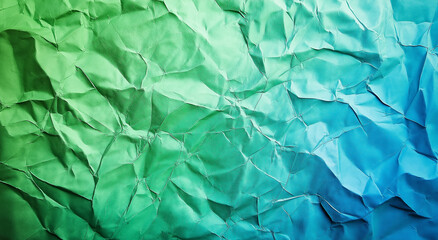 Fototapeta premium A close-up of crumpled green and blue foil, creating a textured background. The wrinkles and folds of the foil add depth and interest, making it visually striking with a unique, vibrant appearance