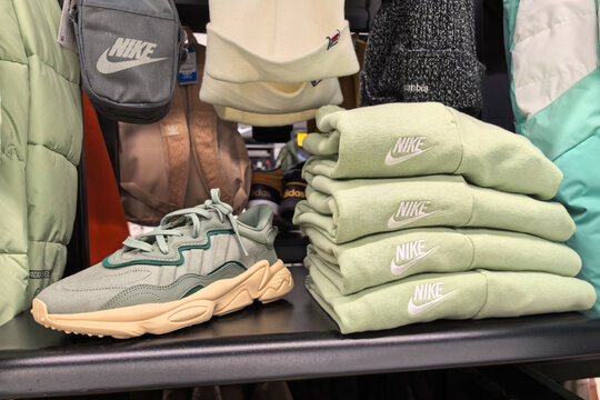 Fashion retail display featuring stylish sneakers and apparel in a vibrant shop